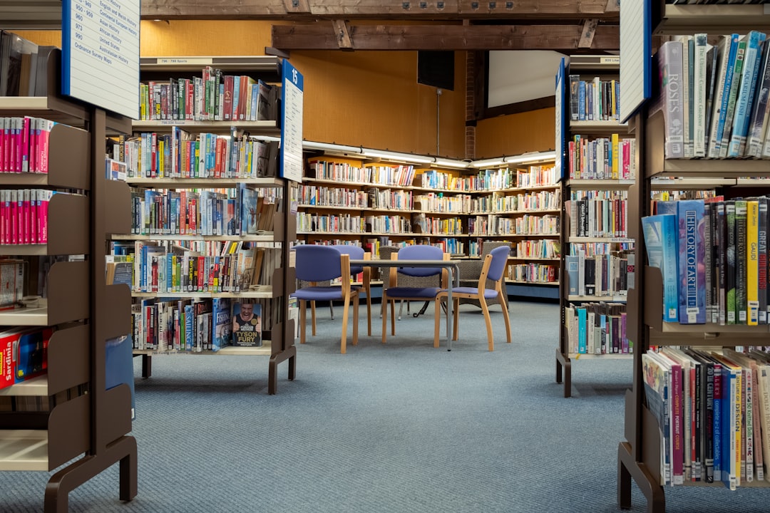 a-library-filled-with-lots-of-books-and-chairs-pcp5zudxgjg