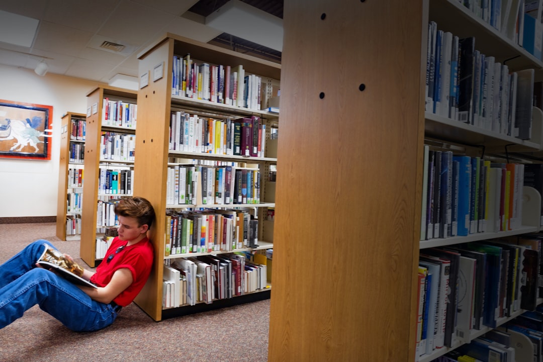 Hondo Hendricks reads a book while sitting on the floor of the Marshall Public Library in Pocatello, Idaho, April 1, 2025.